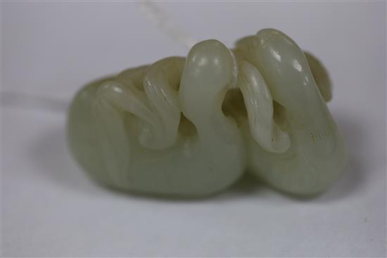 A Chinese pale celadon jade carving of two ducks biting lotus, 19th century L. 5.3cm
